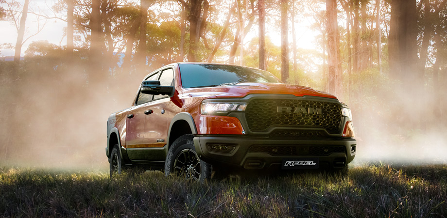 A red RAM Truck in a misty forest