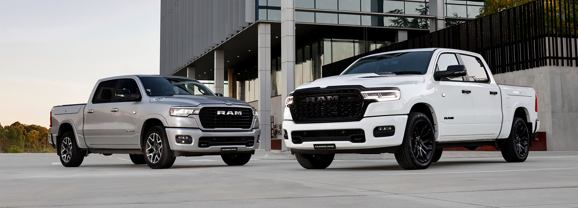 Silver RAM truck parked infront of a building