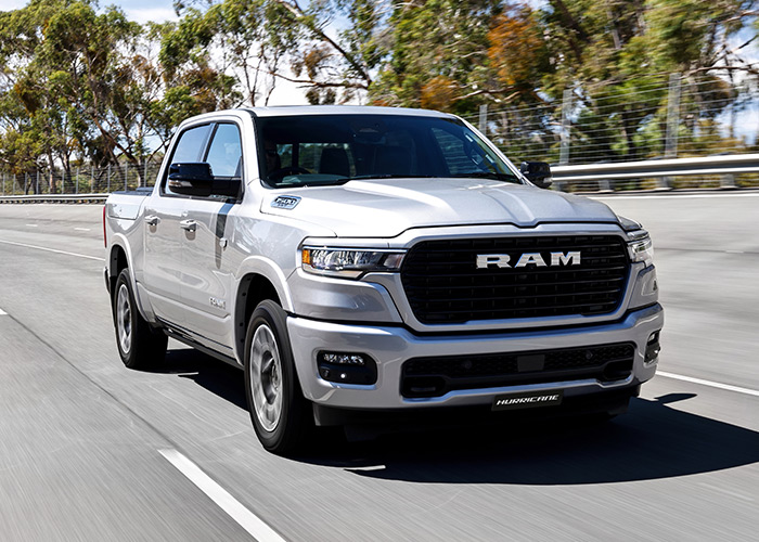 Silver RAM truck driving along a highway