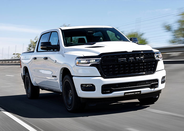 White RAM truck driving along a highway